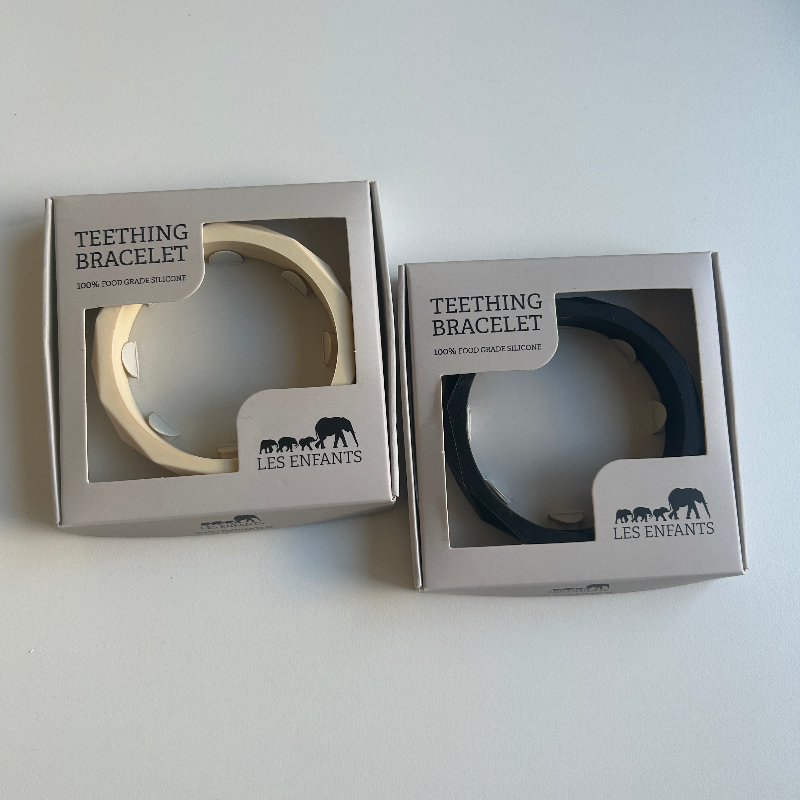 Two teething bracelets in their packaging on a white background
