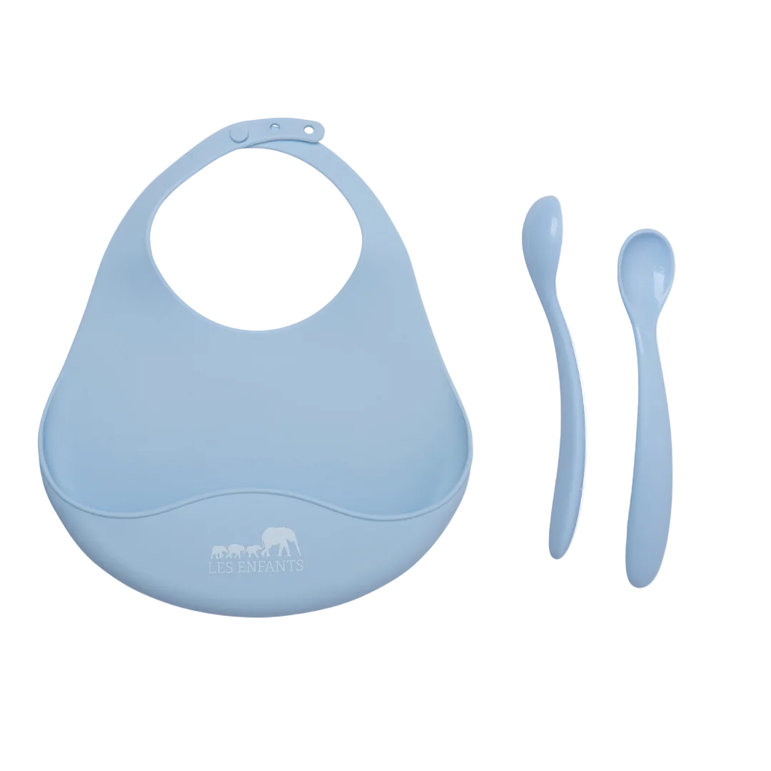Blue baby bib and two spoons on a white background