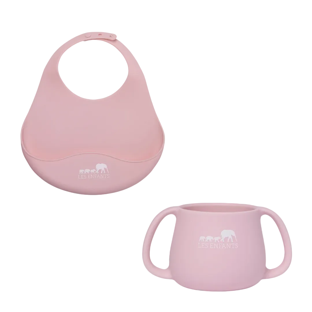 Pink baby bib and cup set on a white background