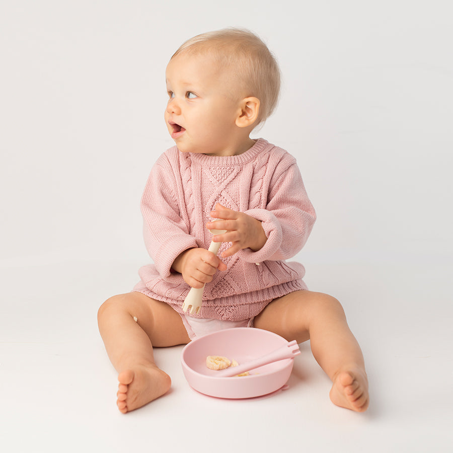 Les Enfants Silicon Baby Bowl and cutlery set pink and sand baby model looking to the side